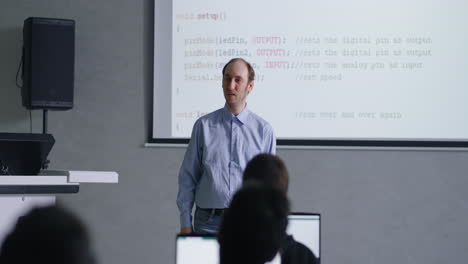 "teacher presenting coding lesson in a classroom"