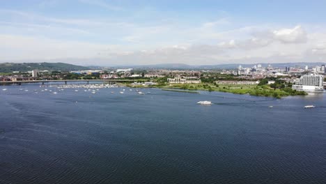 Cardiff-Bay-With-A4232-Link-Road-Bridge-In-The-Distance-And-Boats-Going-Past