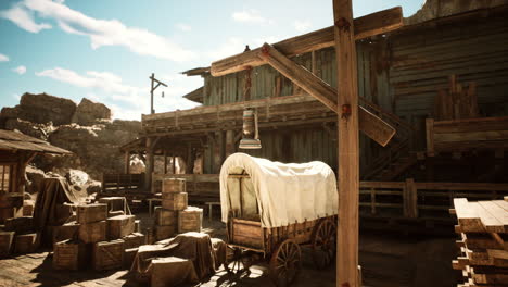 rustic western town with wooden buildings and a wagon in sunlight