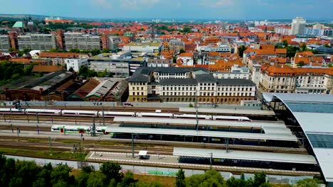 4k aerial drone video of bullet train entering the train station in downtown erfurt, germany