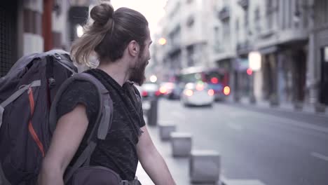 person with a backpack on a city street