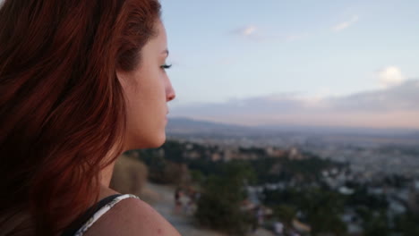 woman overlooking granada at sunset