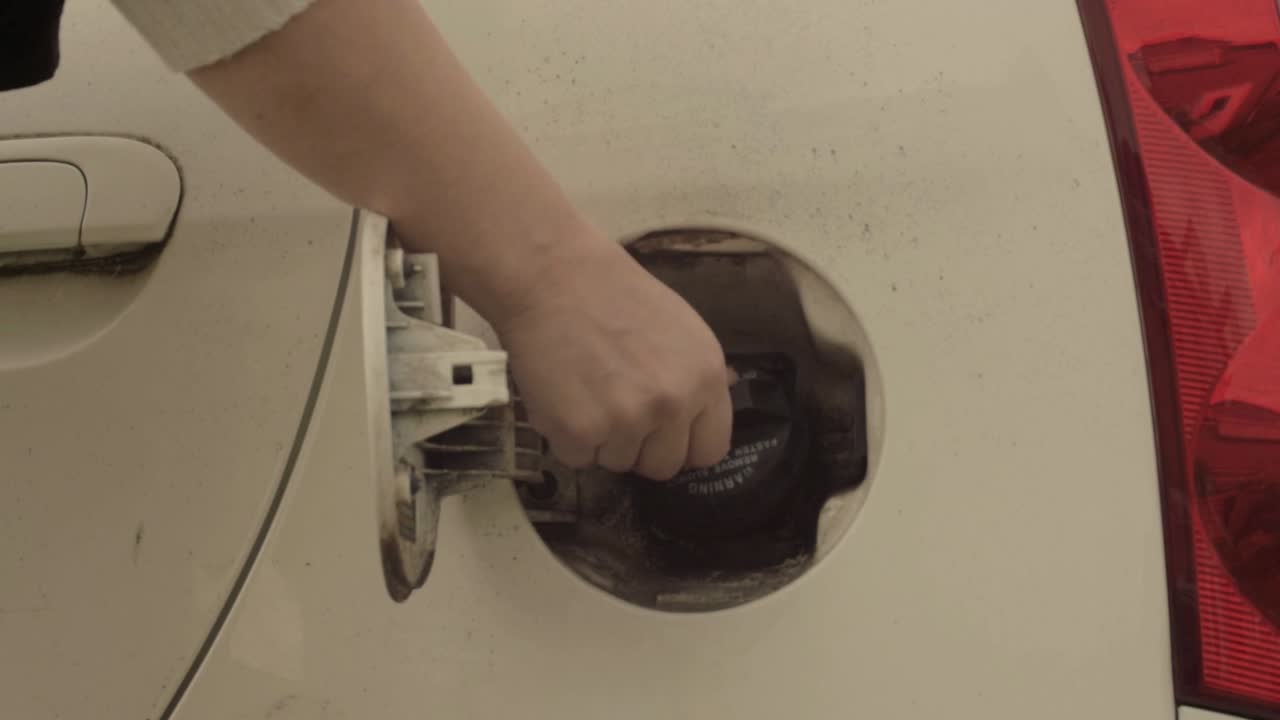 Screwing fuel cap on car