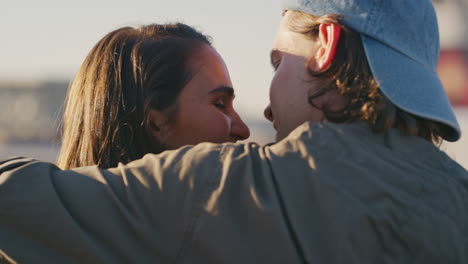 happy group of friends celebrating on rooftop caucasian couple kissing enjoying weekend celebration at sunset