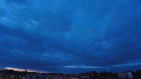 day - night timelapse: heavy overcast rolls over low rise neighborhood