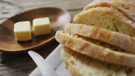 video of bread on chopping wooden board on wooden worktop