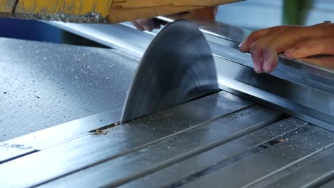 close up of circular steel saw blade sawing stainless steel