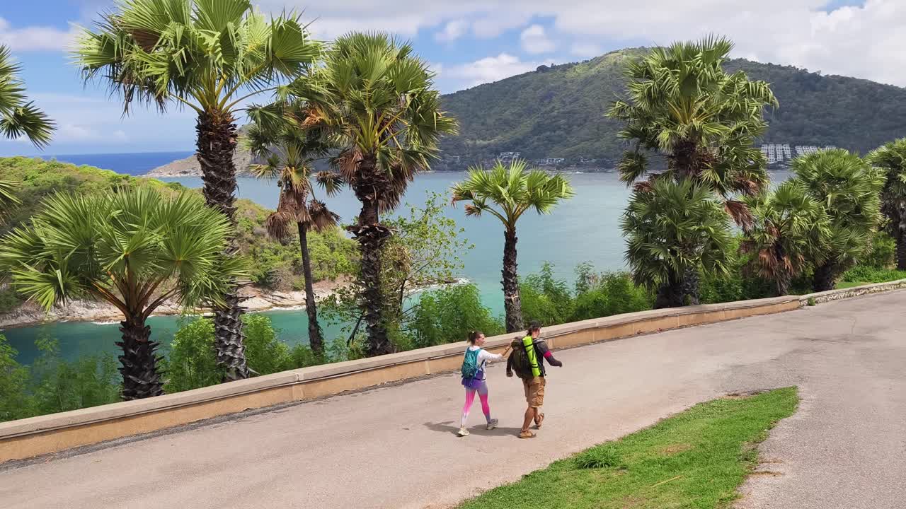 Couple Hiking along a Scenic Coastal Path in Thailand
