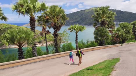 couple hiking along a scenic coastal path in thailand