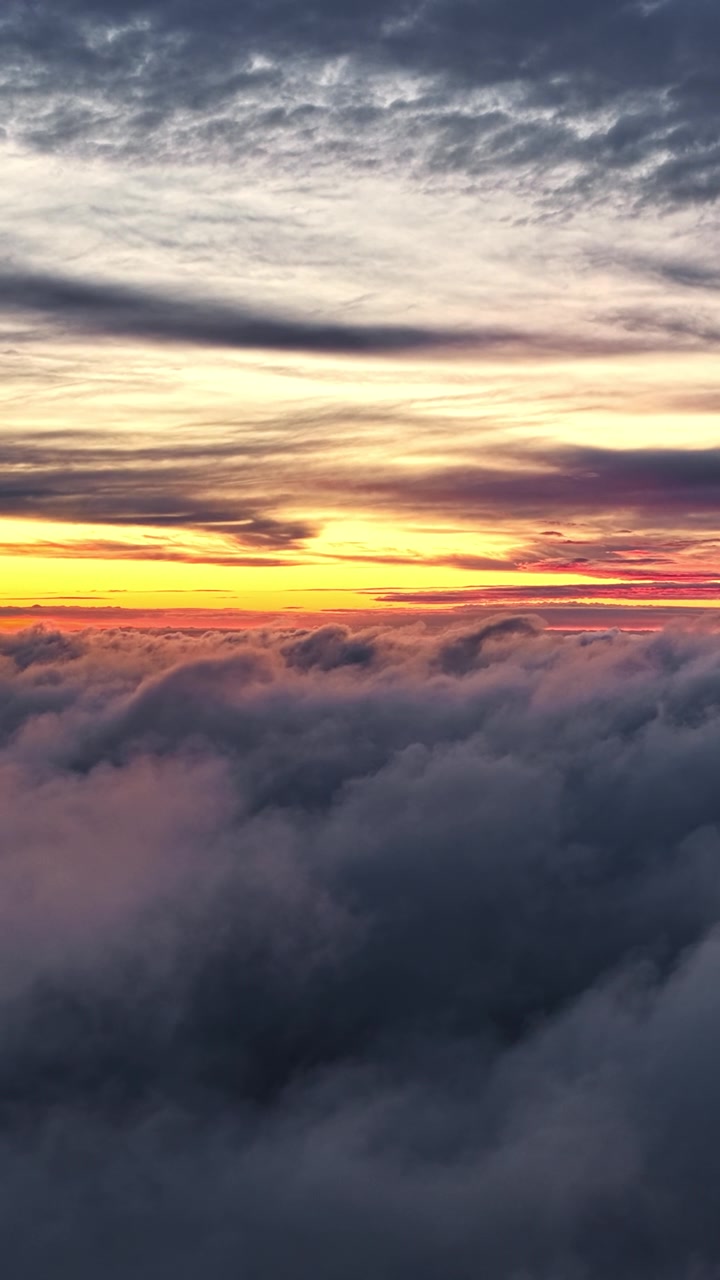 Breathtaking tranquil sky view above clouds at scenic golden hour