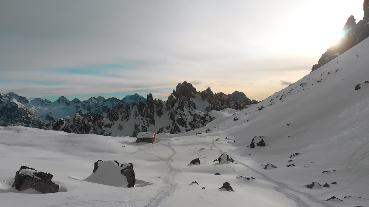 Remote Winter Cabin in Vast Snowy Mountain Landscape