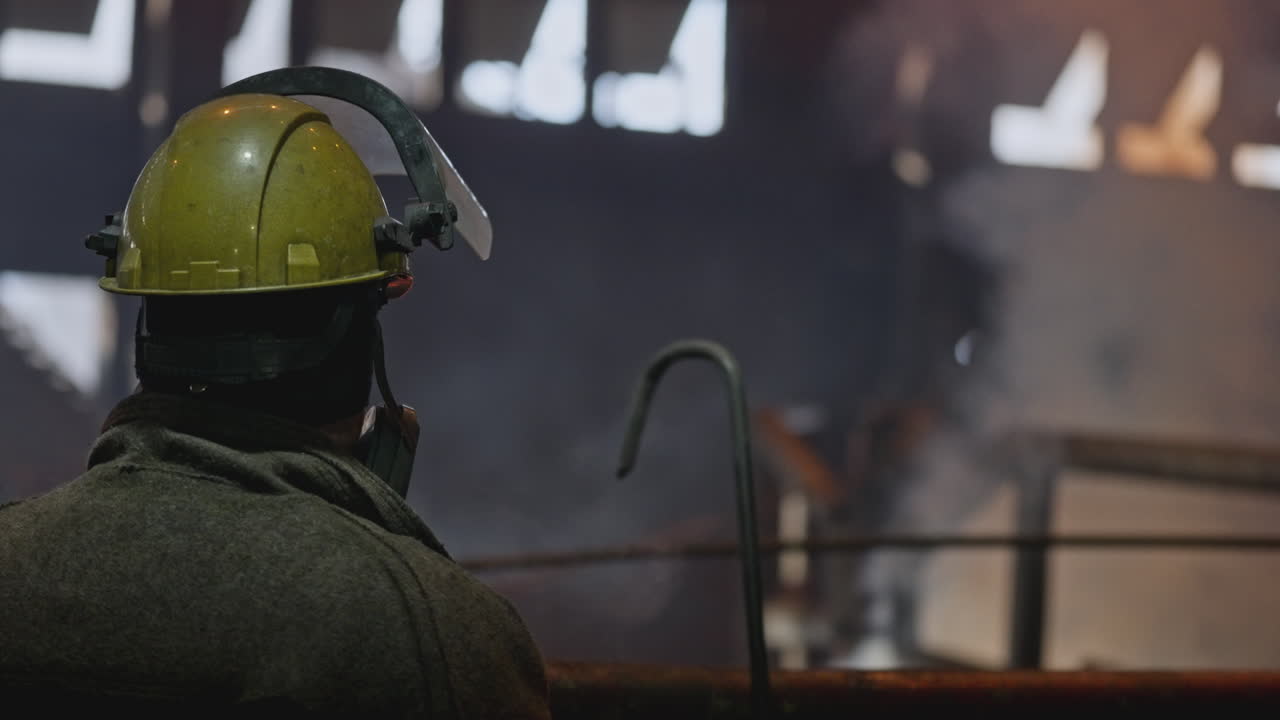 Industrial Worker Observing Hot Metal Process