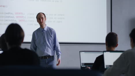 teacher giving a coding lecture in a classroom