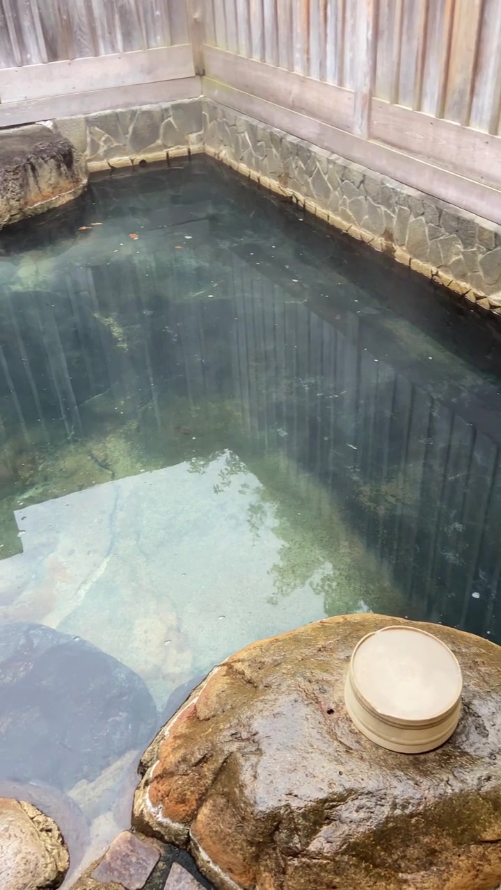 Panoramica su acqua calda fumante in Giappone. Bagni tradizionali o spa chiamati Onsen. Piscina esterna per sessioni di relax private o di coppia in hotel o resort termale. Turismo e rituale culturale. Reel in stile UGC.