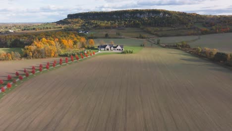 a farmhouse and vast fields with fall colors near burlington, ontario, canada, aerial view
