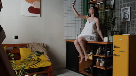 woman taking picture on herself on countertop