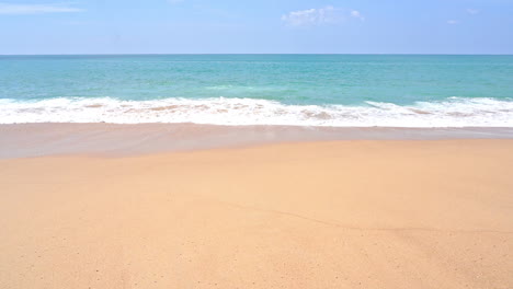 empty wild yellow sand beach with beautiful sea waves coming toward beach daytime