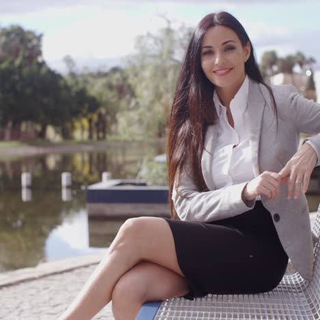 gorgeous business woman sitting on bench