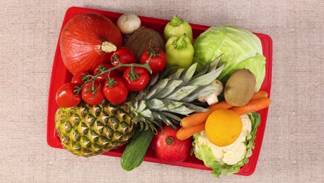 red tray full with fruits and vegetables moving. stop motion