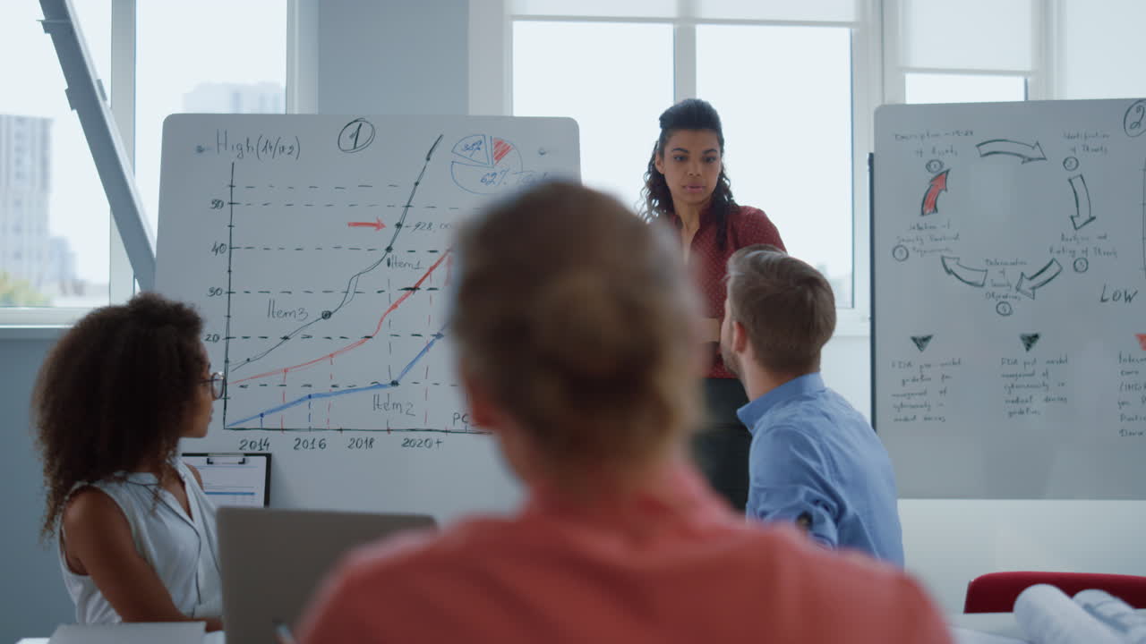 아프리카 여성이 이사회에서 전략을 제시하고 있습니다. 여성 코치가 직원을 가르 ⁇ 니다.