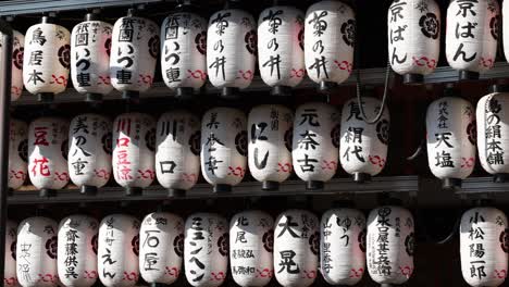 rows of white lanterns with japanese characters