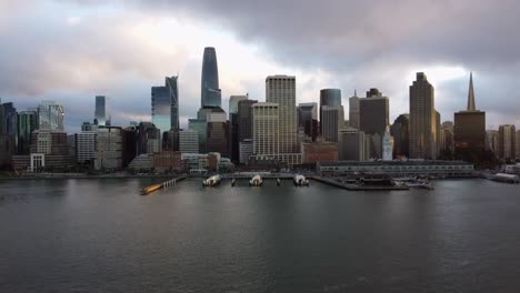 4K-30fps-Tracking-Up-Aerial-Drone-Footage-of-San-Francisco-City-Skyline-and-the-SF-California-Bay---Epic-Skyscrapers,-piers-and-harbors,-Port-of-San-Francisco-Building,-Stormy-Sunset,-Waterfront-Coast