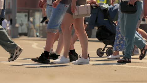 the feet of people at the crosswalk.