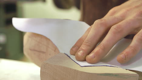 worker in bespoke shoemakers drawing template for last