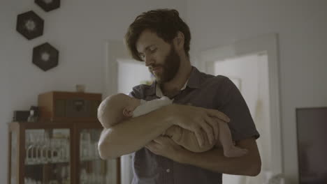 father holding sleeping baby