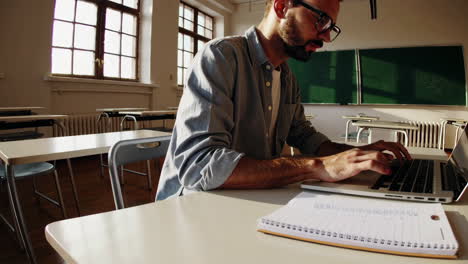 student working on laptop in classroom