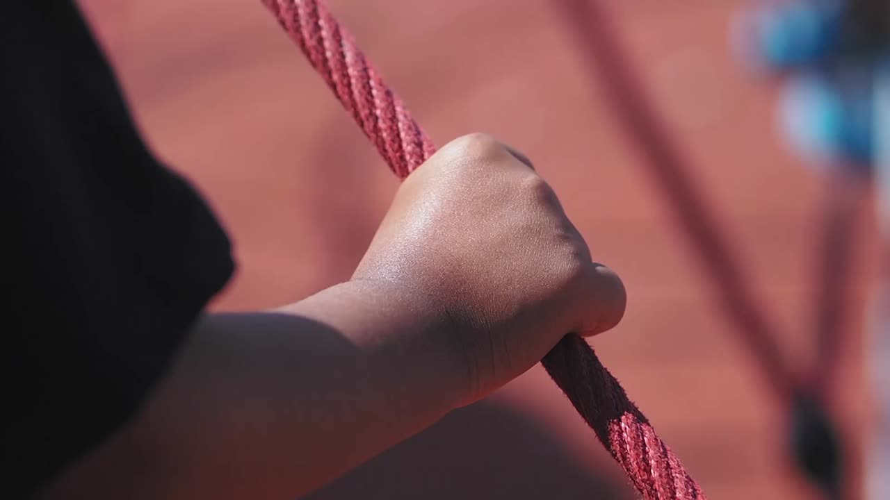 Child's Hand Gripping a Rope