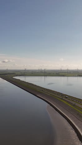 dutch coastal landscape with windmills and highway
