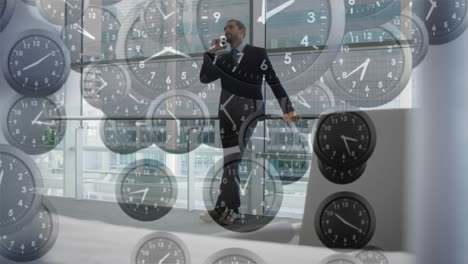 animation of falling clocks with fast hands over caucasian businessman talking on smartphone