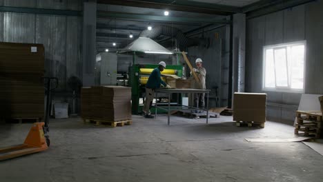 factory workers packing cardboard boxes