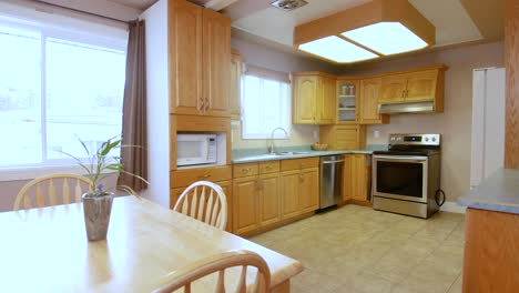 a outdated kitchen and living room space inside a residential family home