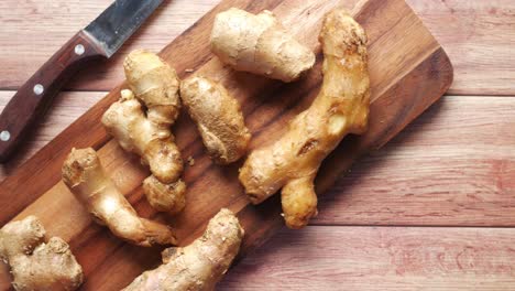 sliced ginger on a wooden cutting board