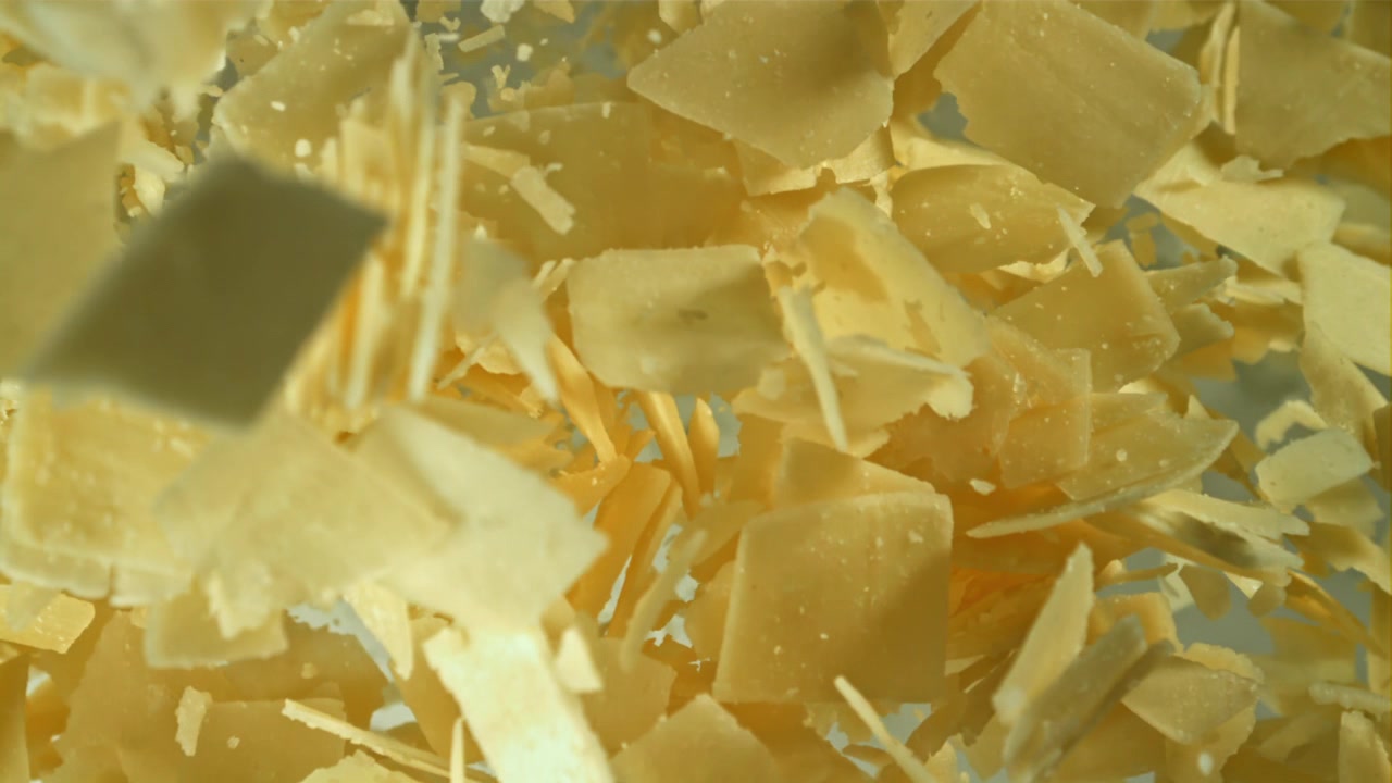 Parmesan Cheese Flakes Falling in Slow Motion