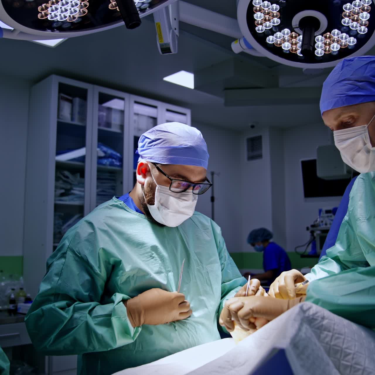 Surgical team working in the modern surgery room. Professional doctors perform operation on foot. Female nurse assisting