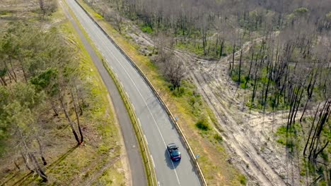 porsche driving along the dune filmed with a drone