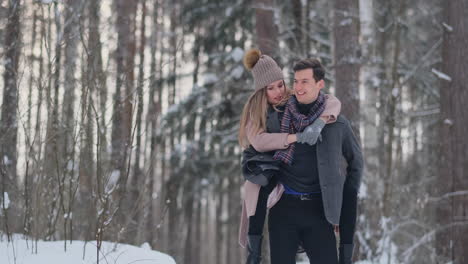 Young-Beautiful-Couple-Taking-Fun-and-Smiling-Outdoors-in-Snowy-Winter