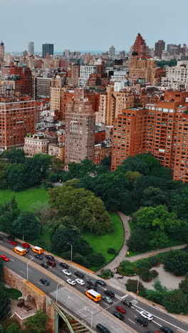 lush greenery on both sides of busy highway on the waterfront of hudson river. beautiful cityscape of new york at daytime. top view.