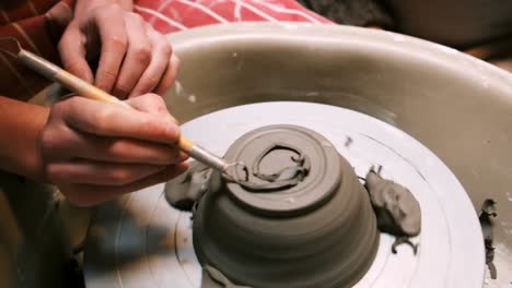 mid section of potter making pot