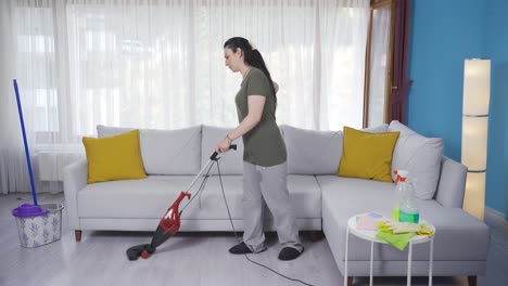 The-woman-sweeping-the-house.