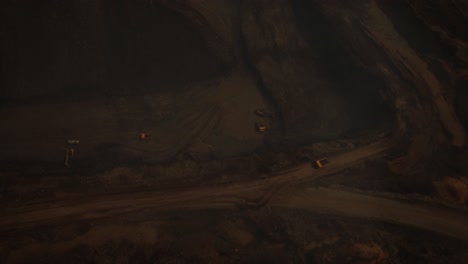 arial view of the opencast mine. front end loader loading sand into dump truck in open pit. heavy mining machinery working in quarry. truck transports minerals in opencast