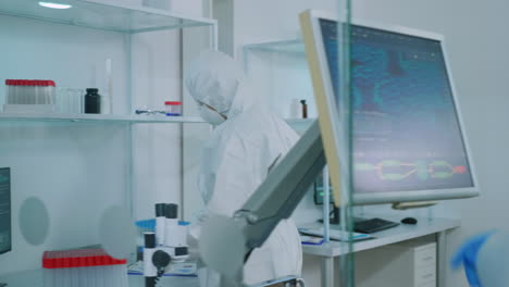 biochemists nurse in protection suit bringing test tubes