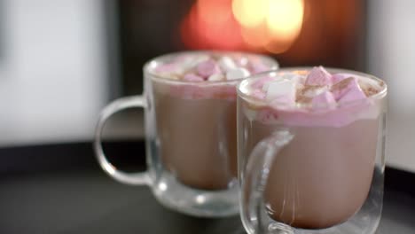 close up of cups with desserts, slow motion in front of open fire, slow motion