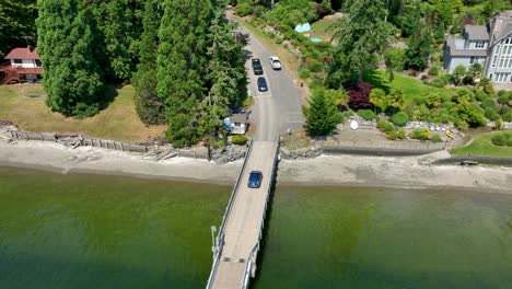 Aerial-view-of-a-car-driving-off-the-Herron-Island-ferry-dock