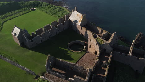aerial view downwards on the castle of dunnottar showing details of the build and the gardens