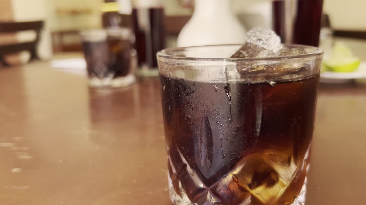 closeup of an appetizing glass of sparkling cola with ice