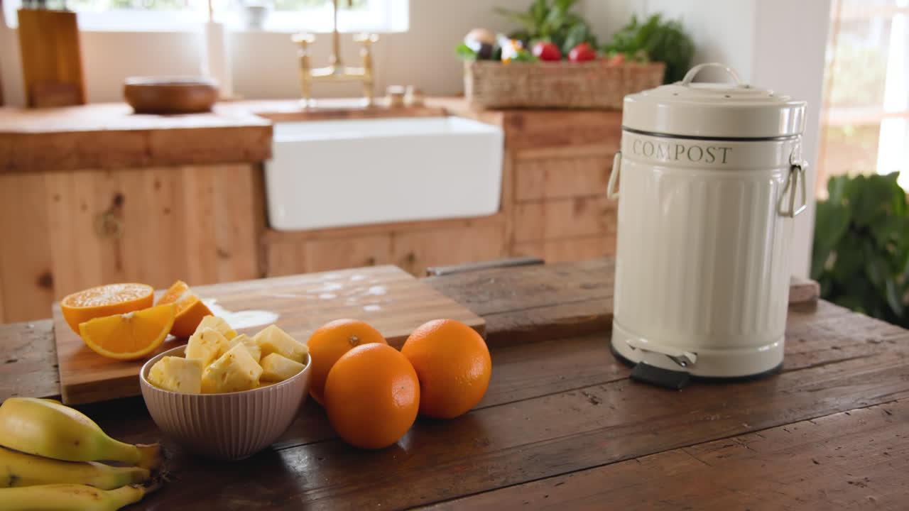 Fresh fruit and compost bin on rustic kitchen counter, promoting sustainable living, at home